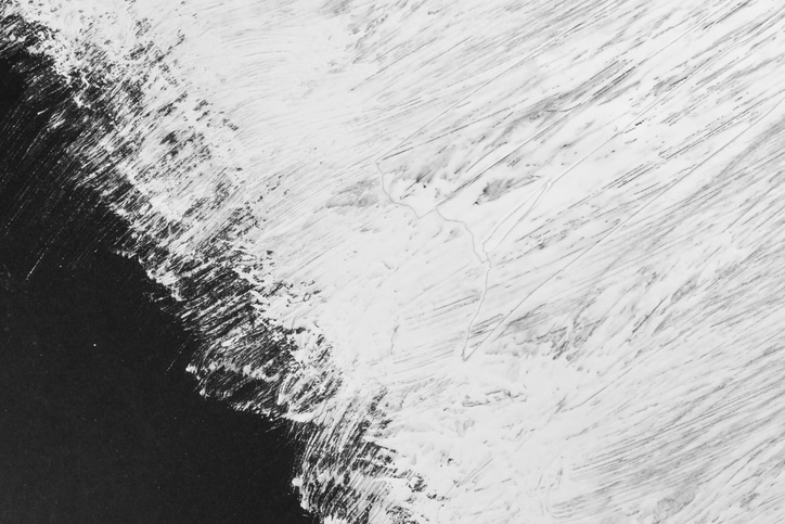 White paint smudge stroke on black old paper sheet